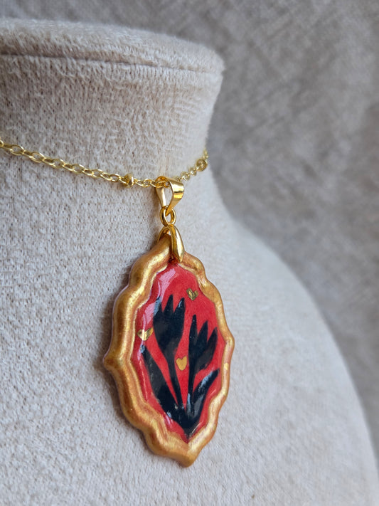 Medalla coral y azul marino con pátina dorada, detalles en oro y cadena con baño de oro