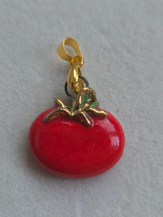 Dije de tomate con oro